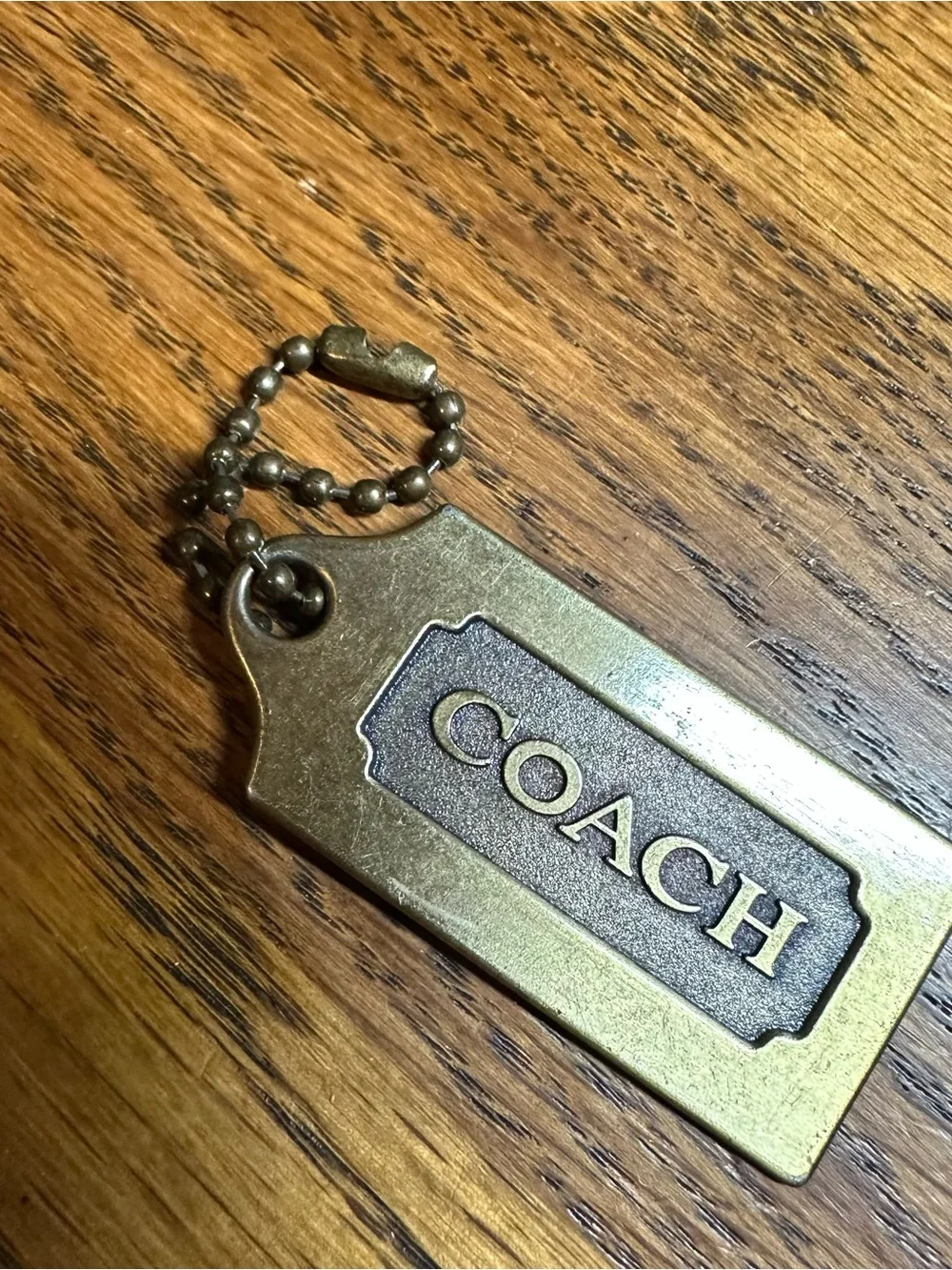 Coach brass tag
